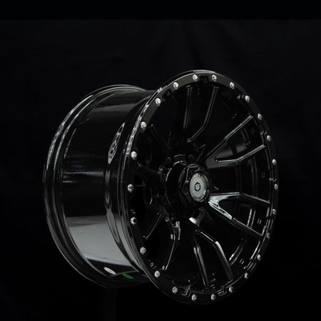 Outlaw Off-Road Rugged 1 gloss black alloy wheel at a three-quarter angle showing spoke depth
