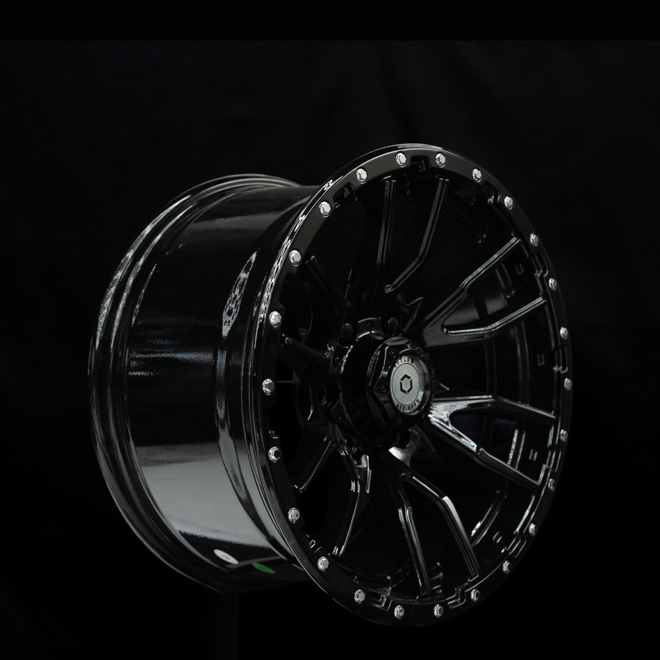 Outlaw Off-Road Rugged 1 gloss black alloy wheel at a three-quarter angle showing spoke depth