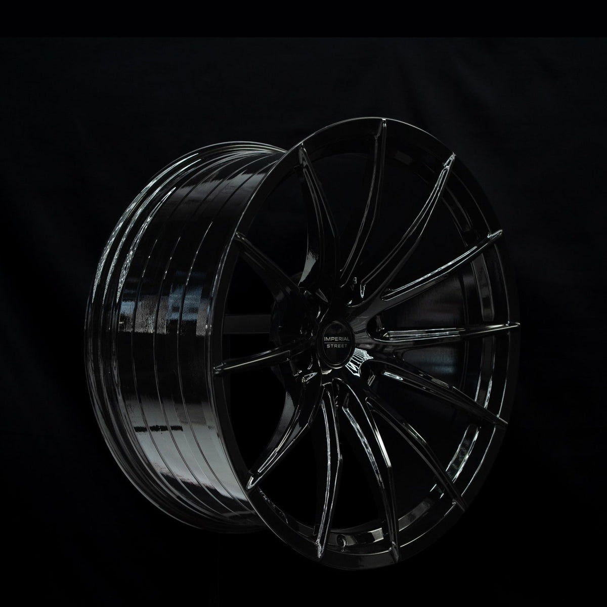 Imperial Street Series 4 gloss black alloy wheel at a three-quarter angle showing spoke depth